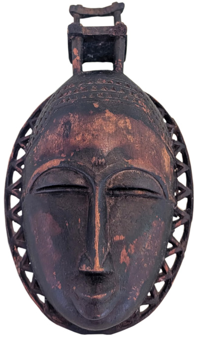 Carved wooden mask of a woman with a chair on her head