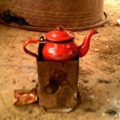 Teapot warming over coals